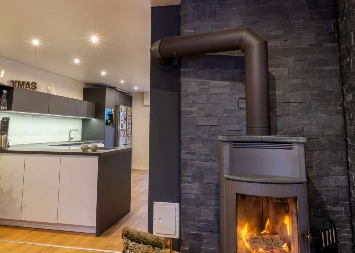a fireplace in a room with stretch ceiling from SST in Östringen